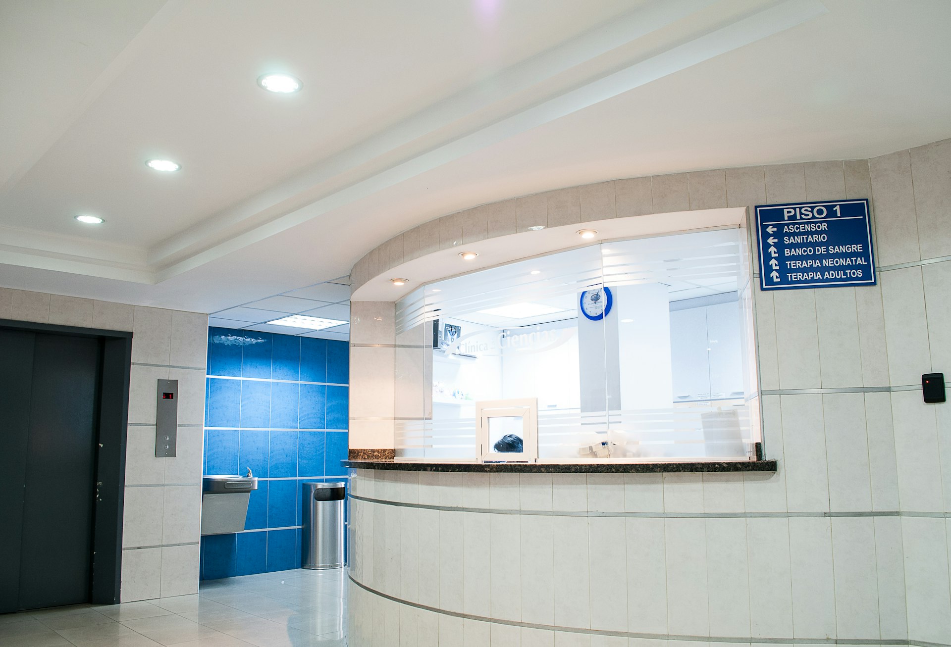 An empty, freshly turned-over patient room with bedrails, call button, and bathroom in frame
